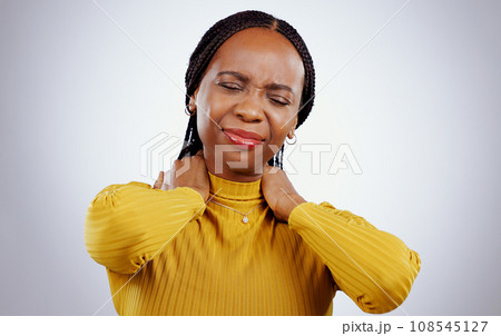 Woman, neck pain and stress or frustrated, studio and inflammation by gray background or tired. Black female person, injury and joint or muscle arthritis, massage and strain or tension of nerve 108545127