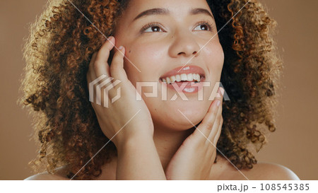 Thinking, happy model or natural beauty dermatology for cosmetics or wellness in studio with smile. Skin glow, woman or confident biracial female person with skincare results on a brown background Thinking, happy model or natural beauty dermatology for cosmetics or wellness in studio with smile. Skin glow, woman or confident biracial female person with skincare results on a brown background 108545385