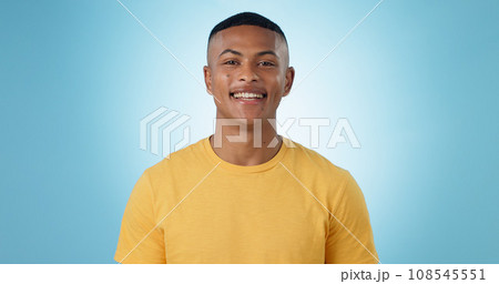 Portrait, young man and smile in studio with confidence, good mood or casual fashion isolated on blue background. Happy gen z model with cheerful personality, pride and mockup space in Puerto Rico 108545551