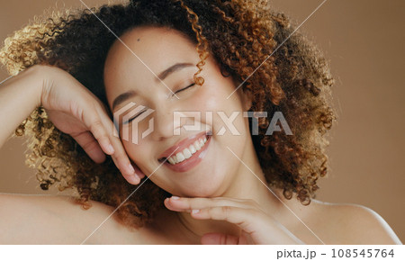 Happy model, natural beauty or smile for wellness in studio with confidence, eyes closed or skin glow. Face, proud woman or healthy biracial female person with skincare results on brown background Happy model, natural beauty or smile for wellness in studio with confidence, eyes closed or skin glow. Face, proud woman or healthy biracial female person with skincare results on brown background 108545764