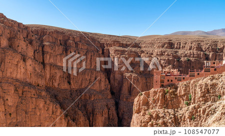 Hotel at the top of Dades Gorges, a series of canyons formed by the Dades River. Red and orange rock formations create a dramatic and picturesque landscape. Hotel at the top of Dades Gorges, a series of canyons formed by the Dades River. Red and orange rock formations create a dramatic and picturesque landscape. 108547077