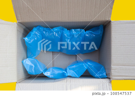 Blue air cushion plastic bags of packaging in cardboard box Blue air cushion plastic bags of packaging in cardboard box 108547537