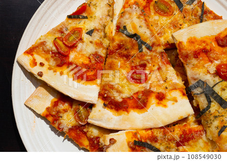 Pizza in white plate on dark background. 108549030