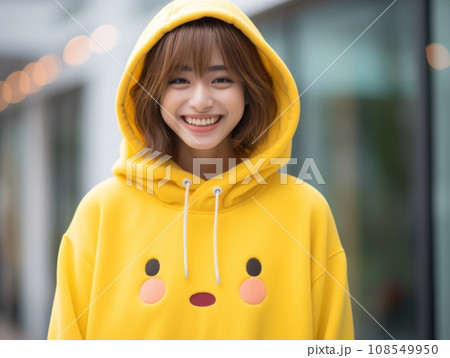 a woman wearing a yellow pikachu hoodie 108549950