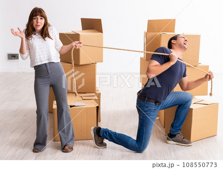 Young pair and many boxes in divorce settlement concept Young pair and many boxes in divorce settlement concept 108550773