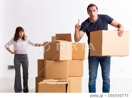 Young pair and many boxes in divorce settlement concept Young pair and many boxes in divorce settlement concept 108550775