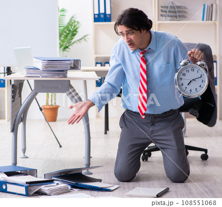 Young male employee unhappy with excessive work 108551068