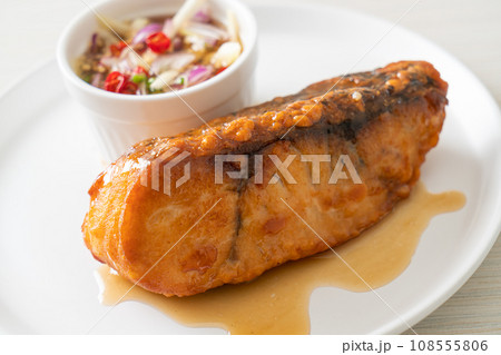 fried snapper fish with fish sauce and spicy salad fried snapper fish with fish sauce and spicy salad 108555806