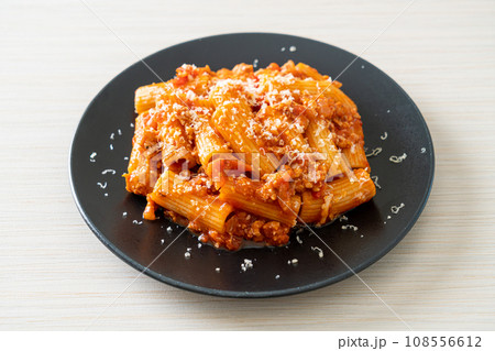 Rigatoni pasta bolognese with cheese 108556612
