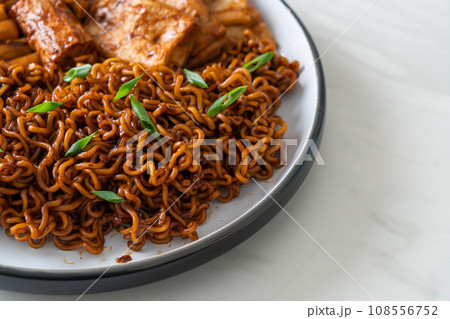 Jajangmyeon or JJajangmyeon with Odeng and Omuk - Korean Instant noodles with Korean fish cake in black bean sauce 108556752