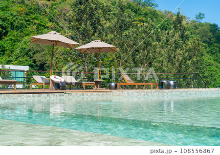 bed pool with umbrella around swimming pool bed pool with umbrella around swimming pool 108556867
