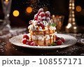 christmas cake with berries and cream night bokeh background 108557171