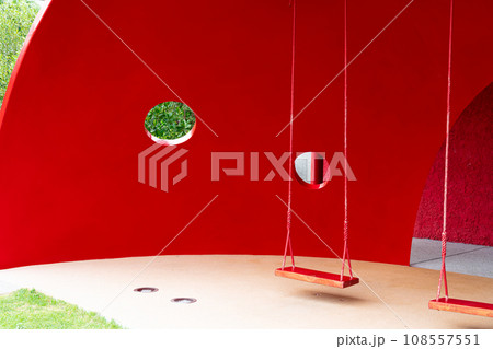 red swing with red background 108557551