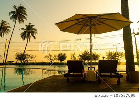 umbrella with bed pool around swimming pool with ocean sea background 108557699