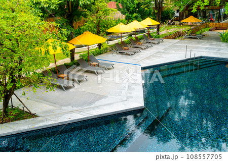 umbrella and pool bed around swimming pool umbrella and pool bed around swimming pool 108557705