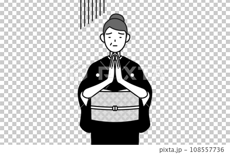 A senior woman in a kimono apologizes with her hands together in front of her body, at a New Year's shrine visit, a wedding ceremony, etc. 108557736