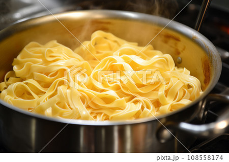 Pot with freshly cooked steaming pasta Pot with freshly cooked steaming pasta 108558174