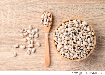 Black eye peas or cowpeas in bowl and spoon on wooden background, Food ingredients, Table top view 108560367