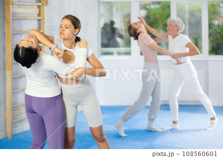 Active women are training captures on self-defense course in gym Active women are training captures on self-defense course in gym 108560601