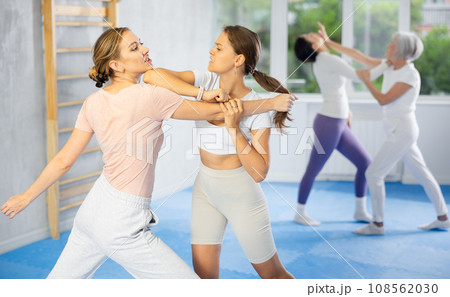 Active women are training captures on self-defense course in gym Active women are training captures on self-defense course in gym 108562030