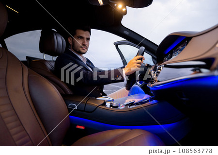 Businessman in luxury car Businessman in luxury car 108563778