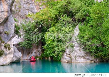 Tourists with instructor on bright inflatable boat go to gorge in Goynuk Canyon, Turkey 108564198