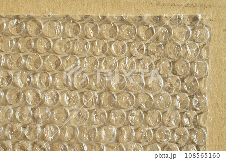 On corrugated cardboard paper plastic air bubble protection foil wrap texture background 108565160