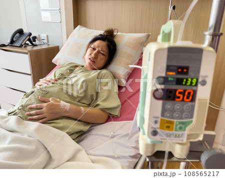 pregnant woman patient has a stomachache on bed in hospital pregnant woman patient has a stomachache on bed in hospital 108565217