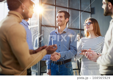 Two happy diverse professional business men executive leaders shaking hands at office meeting. Two happy diverse professional business men executive leaders shaking hands at office meeting. 108565929