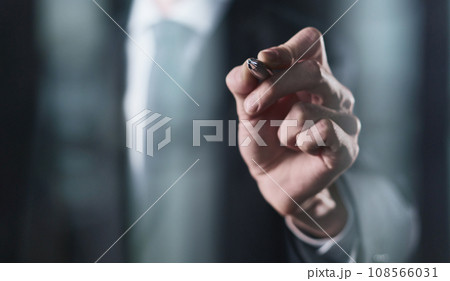 right hand writes with a marker on a transparent board on a black background right hand writes with a marker on a transparent board on a black background 108566031