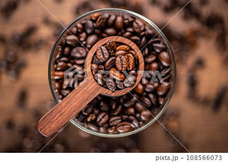 Roasted coffee beans in wooden scoop on wooden table. Top view. 108566073