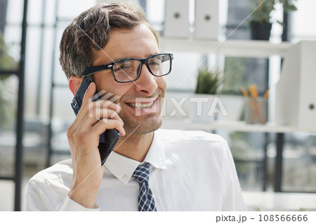 Man accountant or business lawyer talking on smartphone Man accountant or business lawyer talking on smartphone 108566666