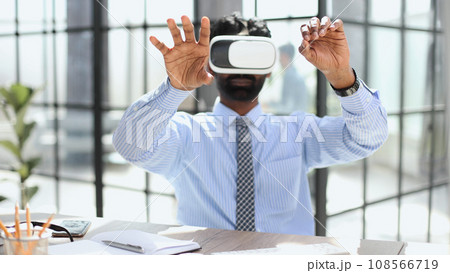 young businessman wearing virtual reality glasses in the office young businessman wearing virtual reality glasses in the office 108566719