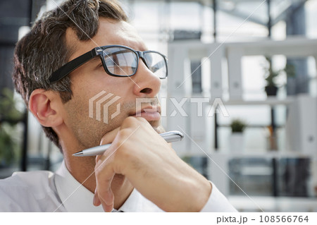 close-up. pensive young businessman in the office looking away. close-up. pensive young businessman in the office looking away. 108566764