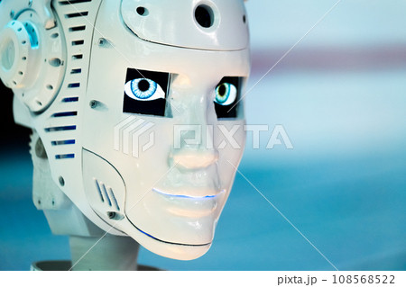 Closeup of white illuminated human robot looking away against blurred background 108568522