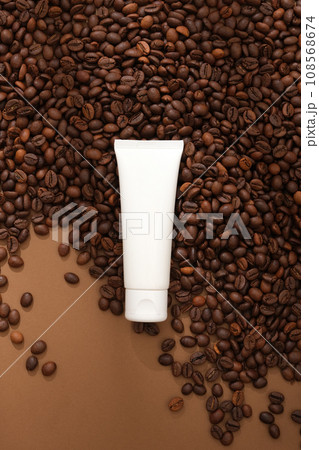 Mockup scene for advertising organic cosmetic with ingredient from coffee. An empty bottle displayed on brown background with lots of coffee beans. Mockup bottle for design packaging Mockup scene for advertising organic cosmetic with ingredient from coffee. An empty bottle displayed on brown background with lots of coffee beans. Mockup bottle for design packaging 108568674