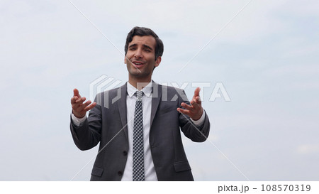 Young handsome businessman in a suit over a pleased expression Young handsome businessman in a suit over a pleased expression 108570319