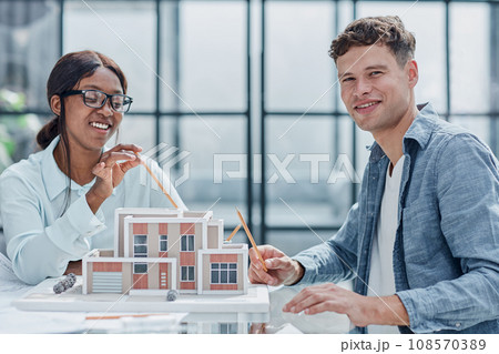 young man and woman designers architects discussing house designs 108570389