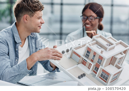 young man and woman designers architects discussing house designs 108570420
