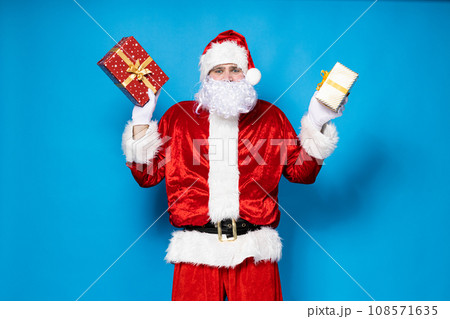 Santa Claus, with gift boxes in his hands. 108571635
