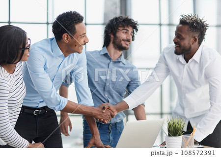 Successful Business Collaboration: Executives Greet with Handshake in Office 108572391
