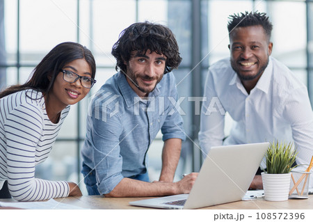 Business professionals in a meeting, collaborating, communicating, and displaying positive teamwork. Business professionals in a meeting, collaborating, communicating, and displaying positive teamwork. 108572396