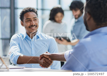 Successful Corporate Cooperation: Professional Business Partners at Indoor Office Meeting Successful Corporate Cooperation: Professional Business Partners at Indoor Office Meeting 108572497