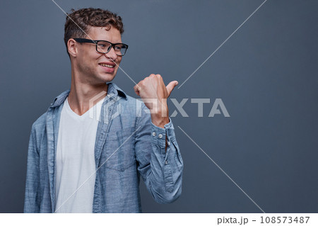 A man on a gray background shows aside 108573487