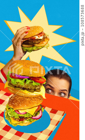 Young emotional woman picking up delicious homemade burger against blue background. Contemporary art collage. Poster. American food Young emotional woman picking up delicious homemade burger against blue background. Contemporary art collage. Poster. American food 108573688