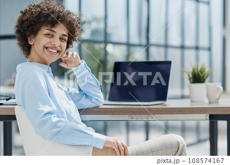 Happy female designer standing in office Happy female designer standing in office 108574167