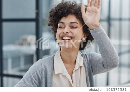 woman in the office greeting her colleagues 108575581