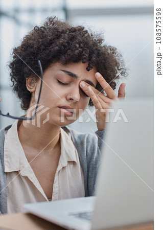 woman in the office is tired of working on the computer. took off her glasses and rubs her eyes woman in the office is tired of working on the computer. took off her glasses and rubs her eyes 108575598