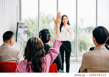 A large group in a seminar classroom raises their hands, actively participating and engaged in the discussion. The audience has the answer in this dynamic conference setting. A large group in a seminar classroom raises their hands, actively participating and engaged in the discussion. The audience has the answer in this dynamic conference setting. 108576125