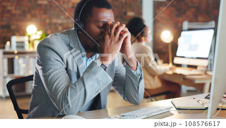 African man, call center and stress by computer, tired or mistake for tech support, glitch or error. Consultant, crm or agent in night, telemarketing or customer service with fatigue, burnout or fail 108576617